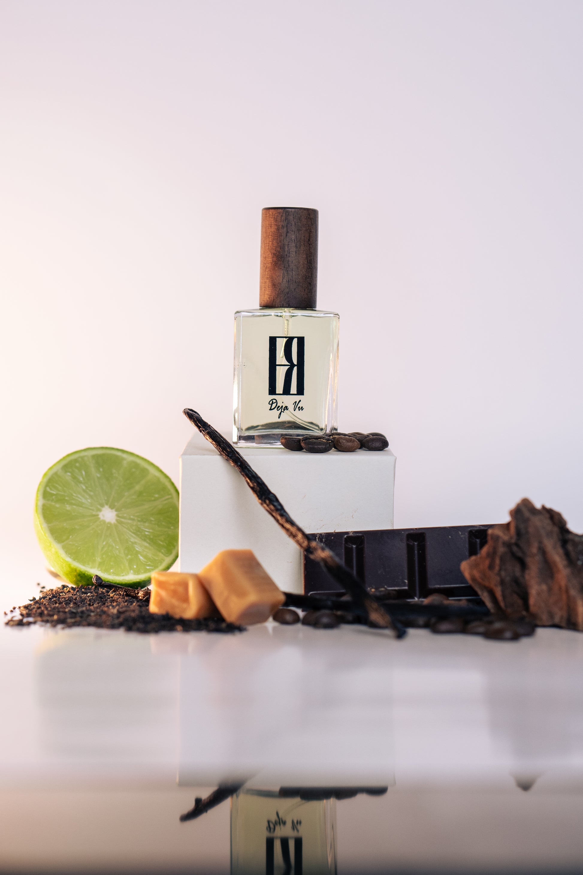 Perfume bottle with ingredients on a white background