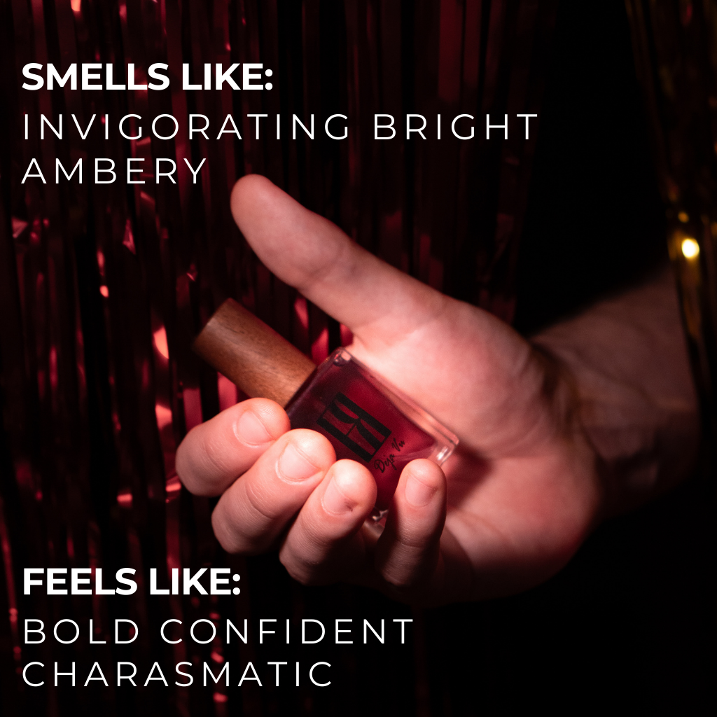Hand holding a midnight celebration cologne bottle with text describing fragrance attributes